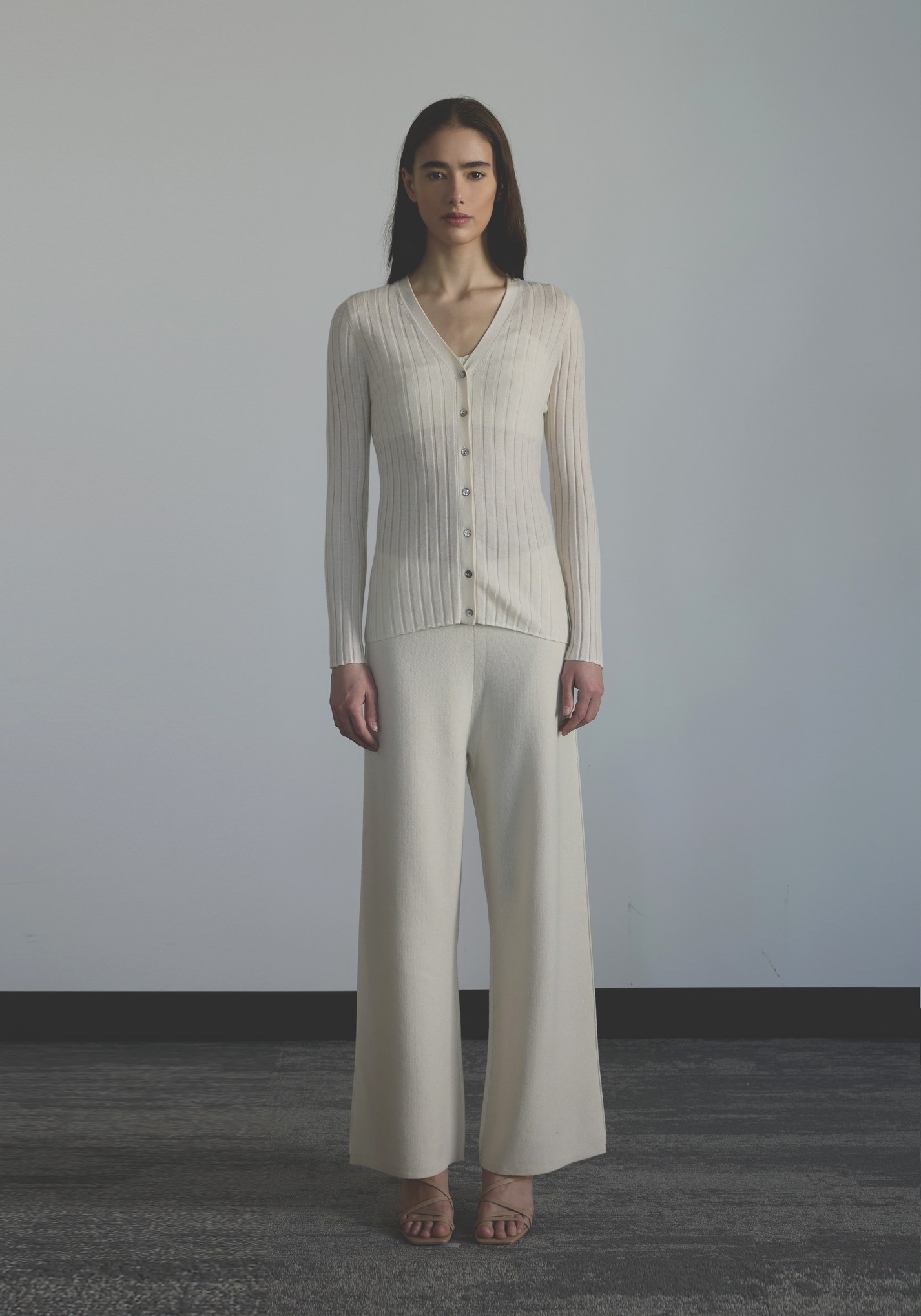 Women’s fine vertical rib cashmere cardigan with deep V-neckline and tonal button closure