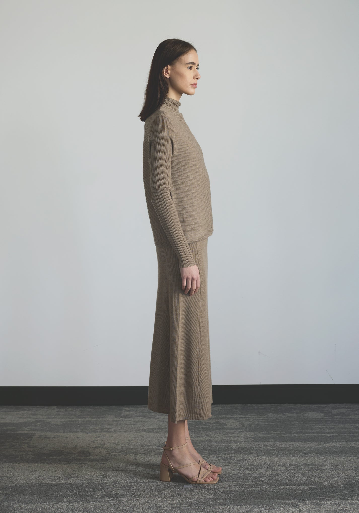 Side view of women’s body-contouring cashmere mock neck knit