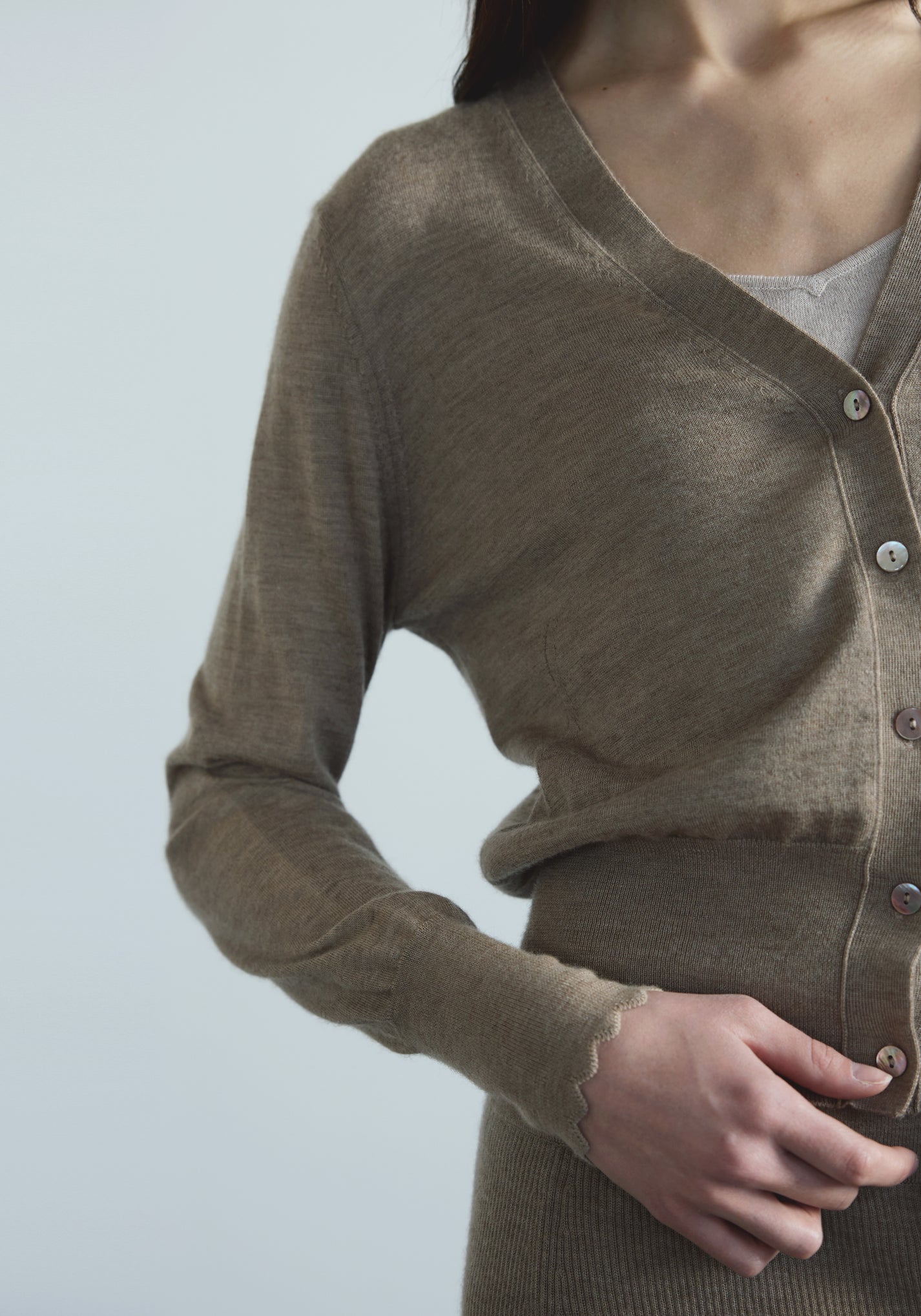 Front view of women’s cashmere V-neck cardigan with softly bloused waist