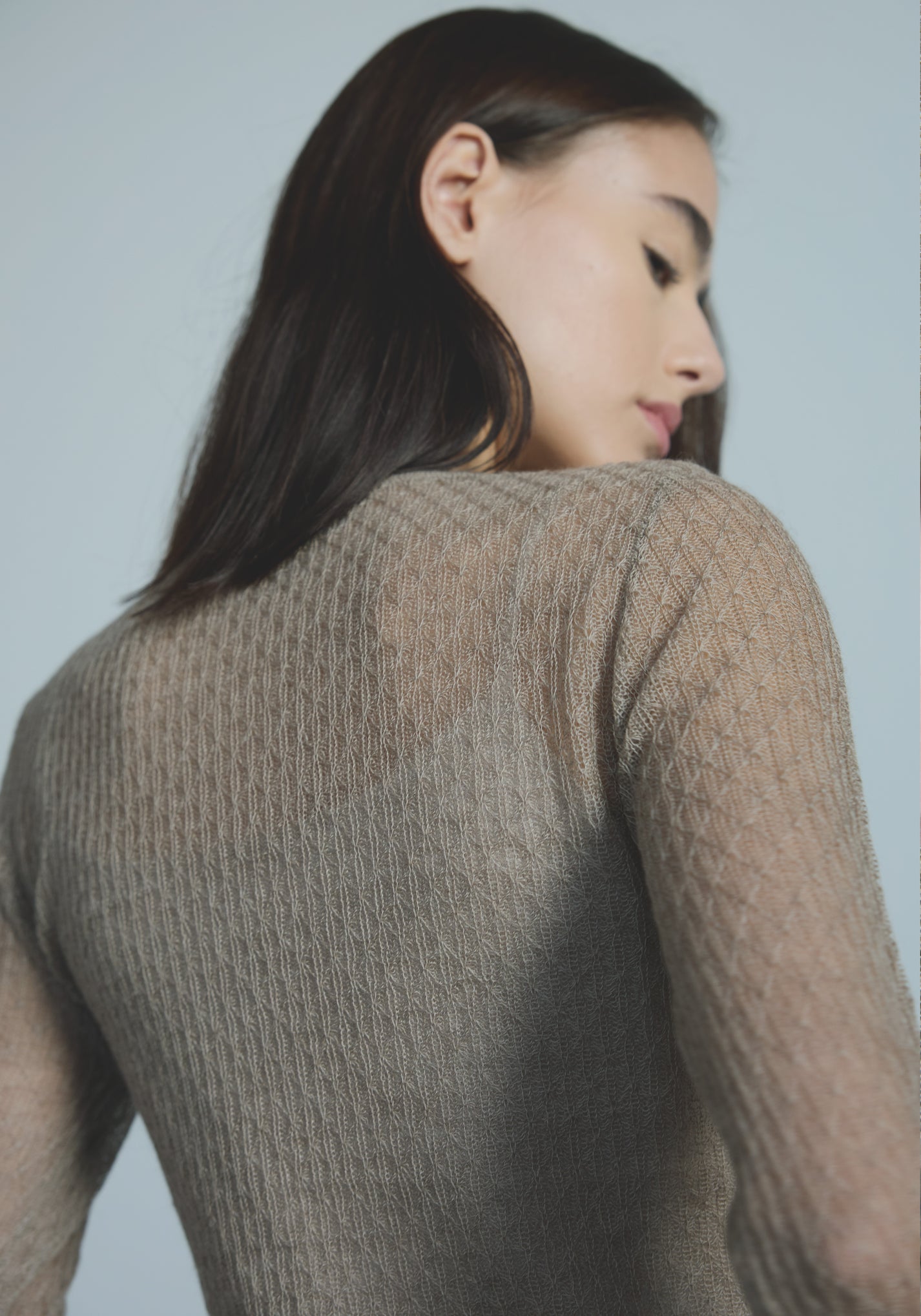 Sheer open-knit cashmere texture on women’s lightweight layer top